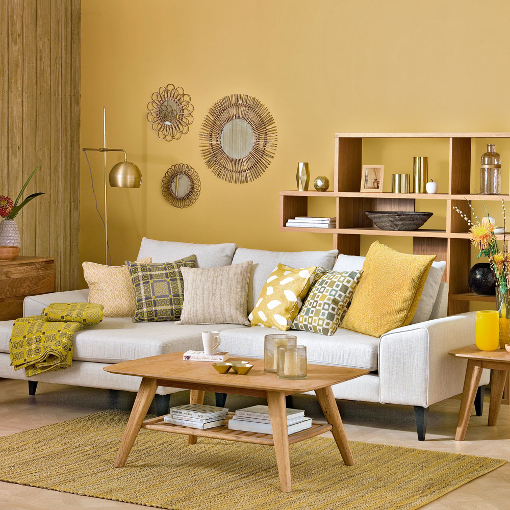 A living room with yellow walls and furniture.