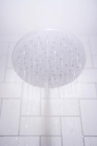 A waterproof shower head in a bathroom.