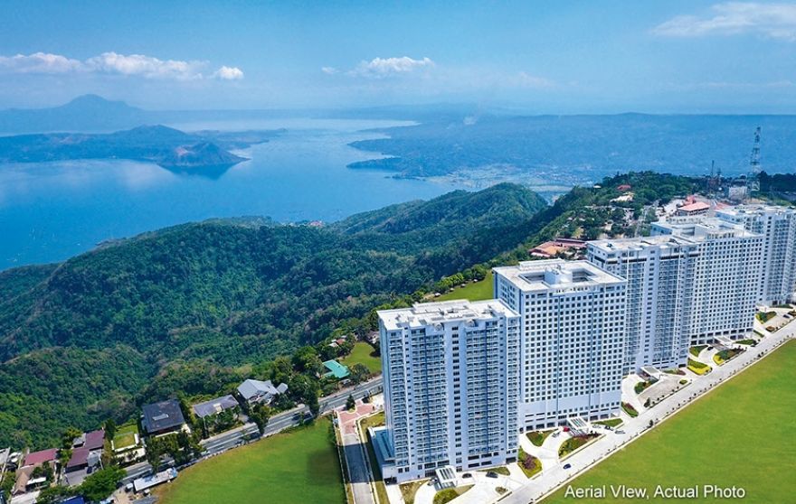 A view of a large apartment complex with a Tagaytay in the background.