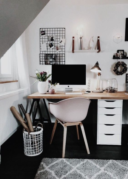 A home office with a pink chair.