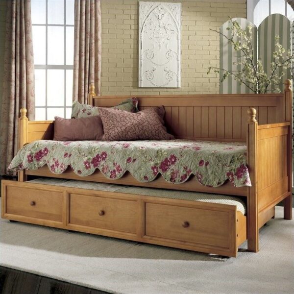 A wooden day bed with a trundle, showcasing different types of beds.