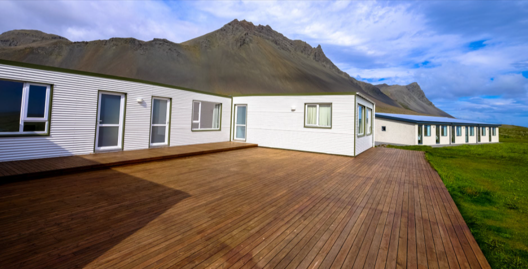A mobile home with a wooden deck.