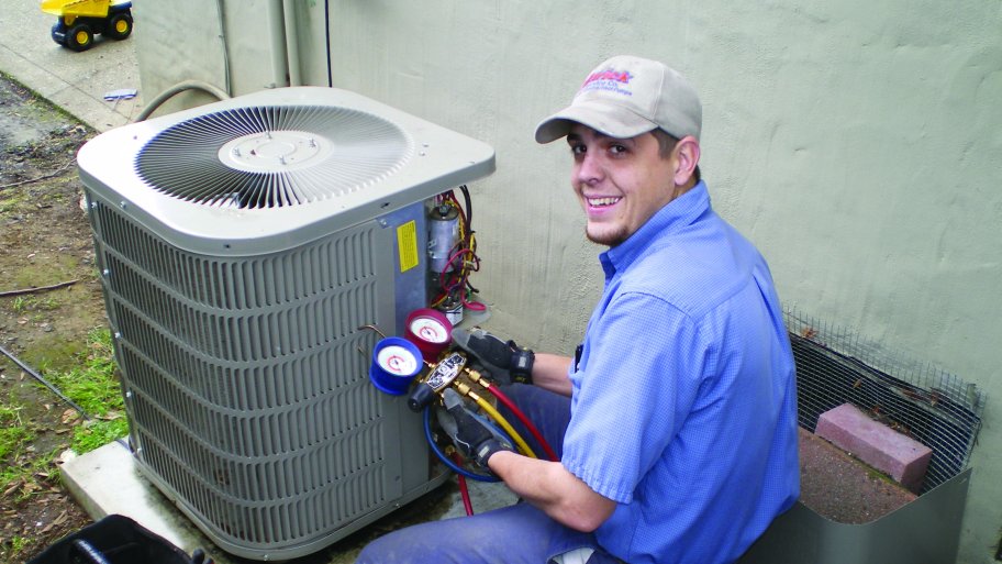 A man servicing an HVAC system.
