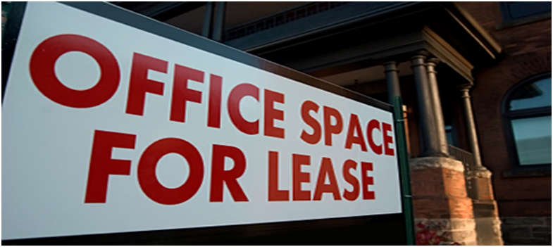 An office space for lease sign in front of a building.