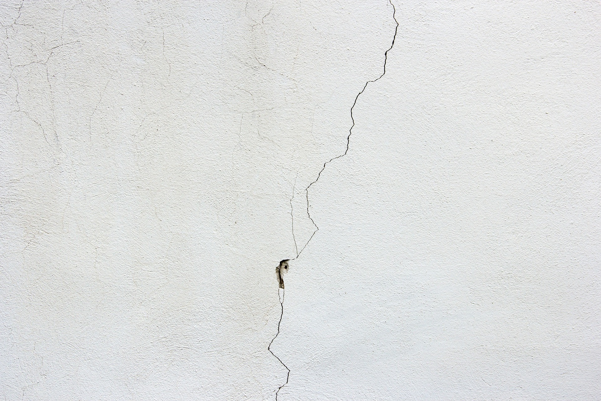 Four signs of foundation damage in a white wall with a crack.

Keywords: Foundation Repair, Signs