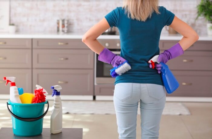 A woman cleaning her home kitchen.