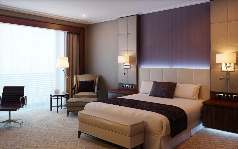 A luxurious hotel room with a comfortable bed and a desk.