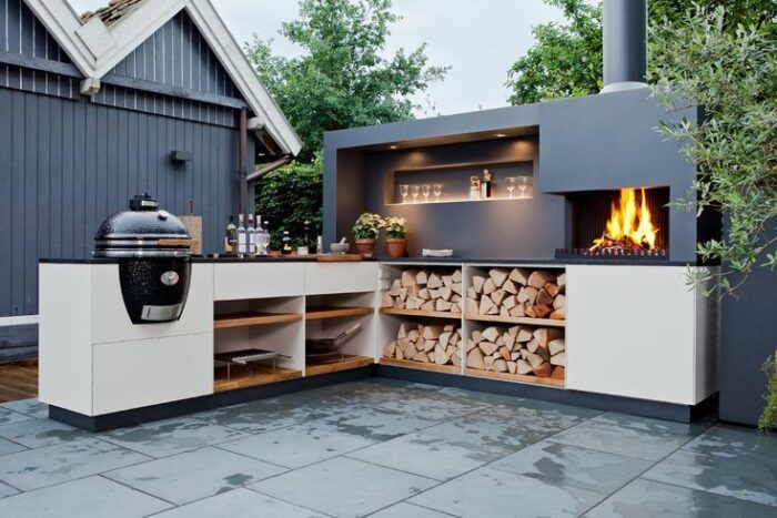 An outdoor kitchen featuring a fireplace.