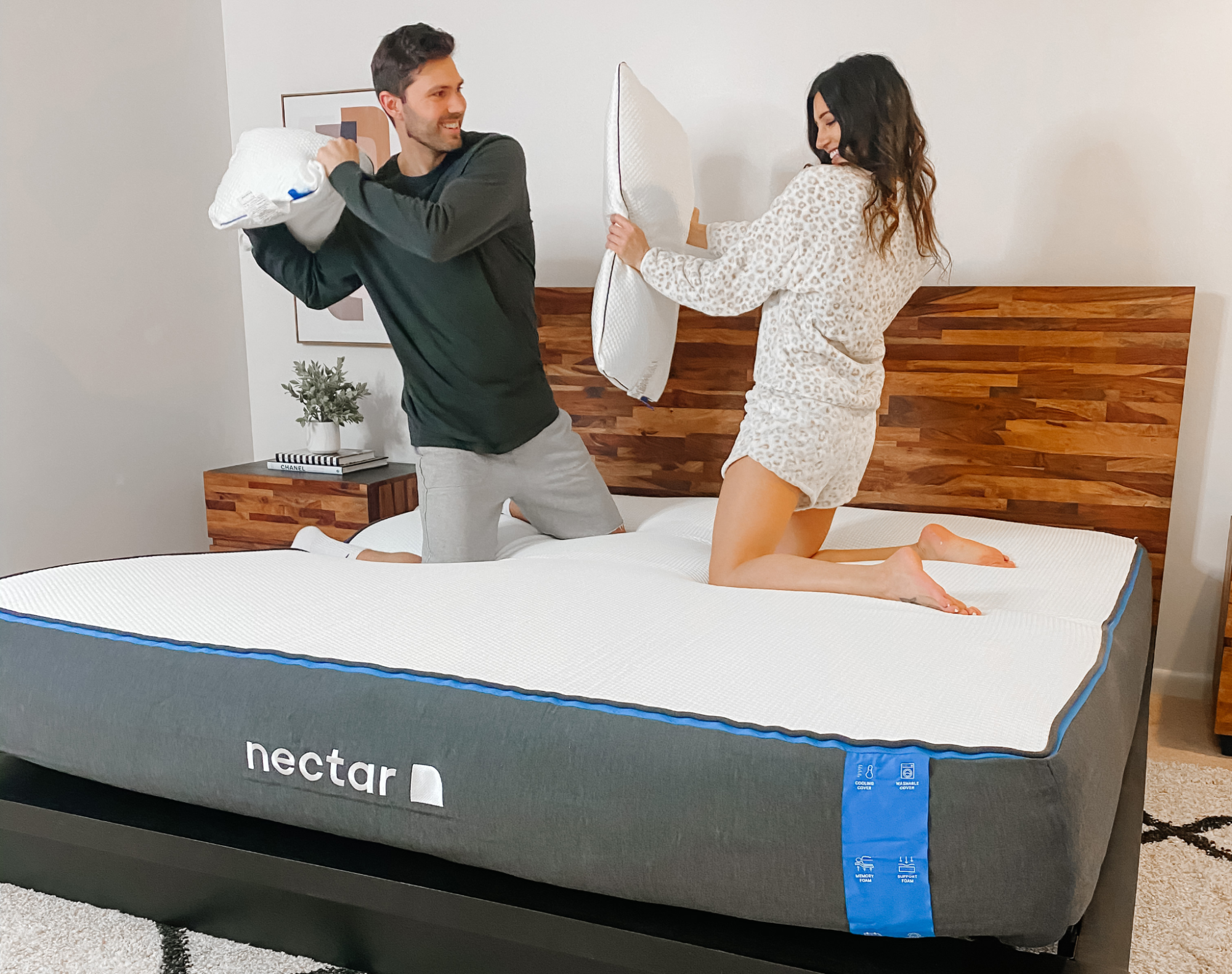 A man and woman testing the comfort of a twin or full mattress.