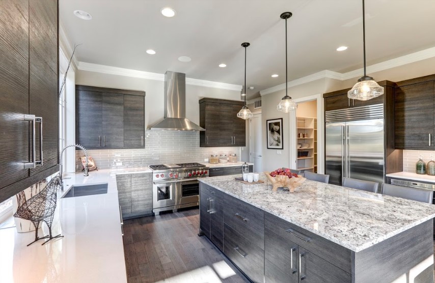 A modern kitchen with granite counter tops.