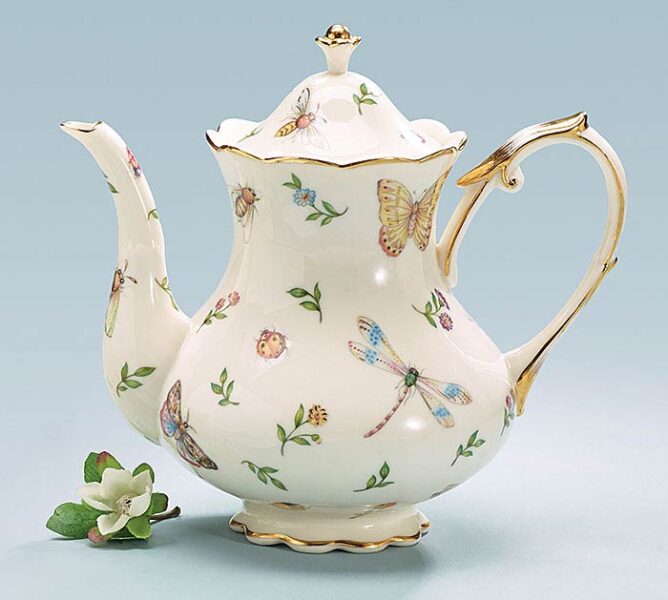 A teapot adorned with butterflies