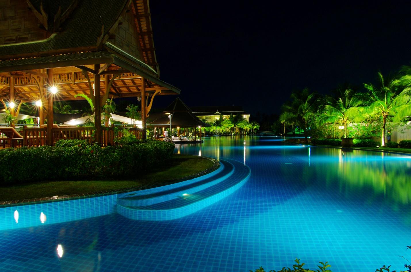 A pool at a resort in Thailand at night.