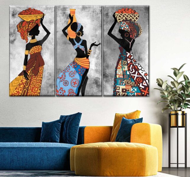 Three African women displaying wall art in a living room.