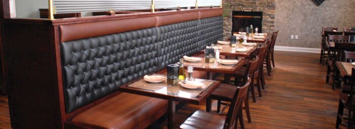 A restaurant with leather booths and tables featuring the best restaurant chairs.