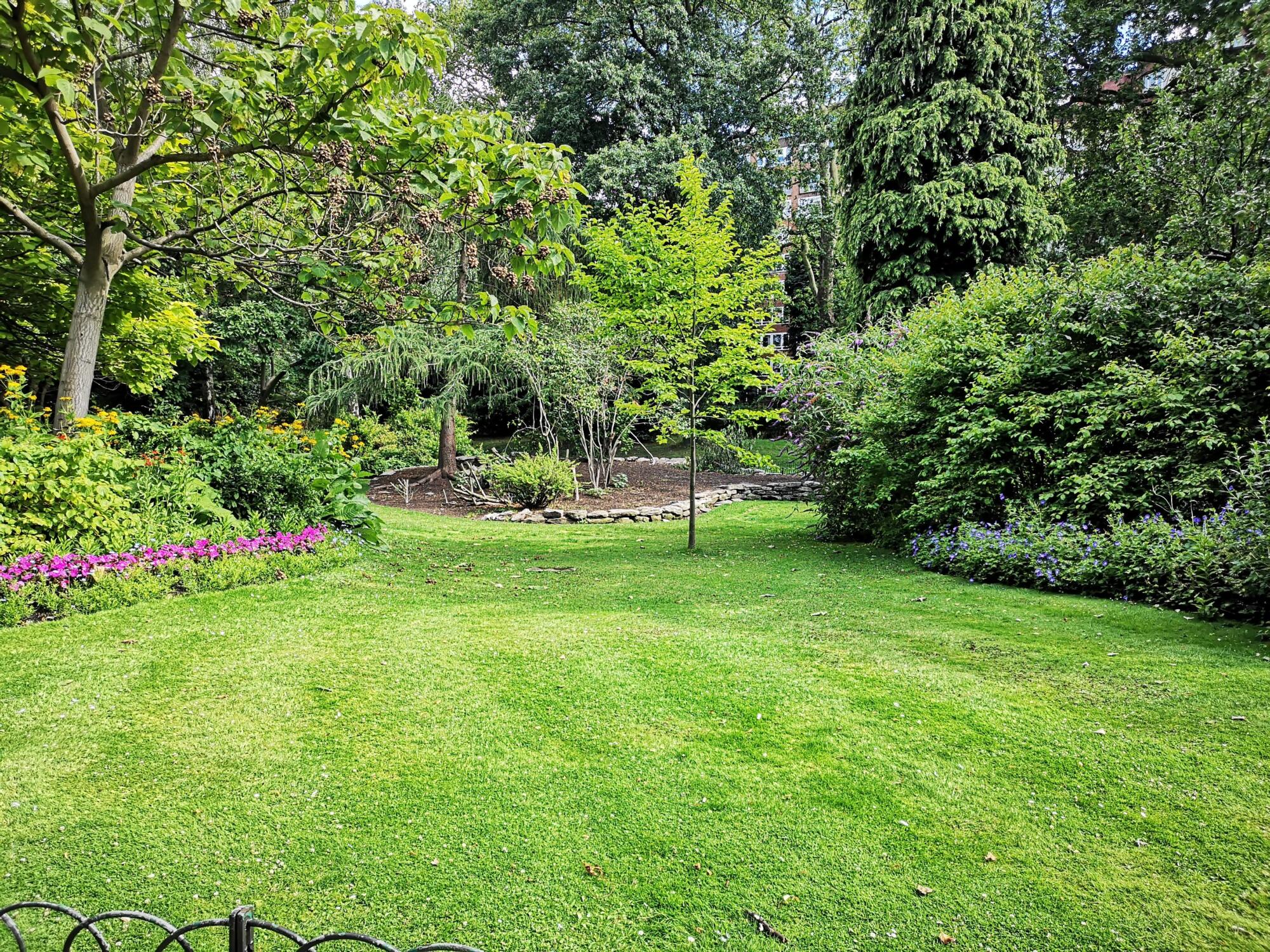 A green grassy area with improved landscaping.