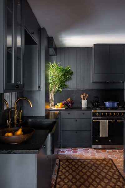 Kitchen design trends with black cabinets and a tiled floor.