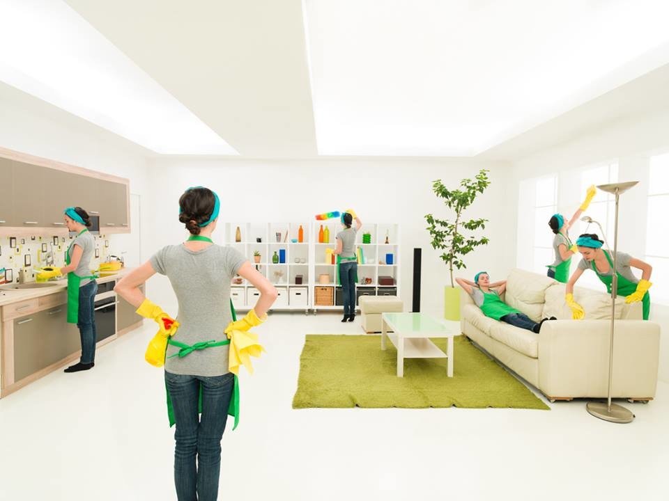 A group of professional cleaners in Brisbane cleaning a living room.
