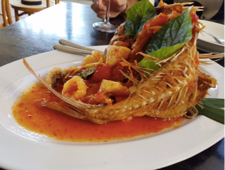 A plate with a fish in a sauce served at restaurants in the Sutherland Shire.