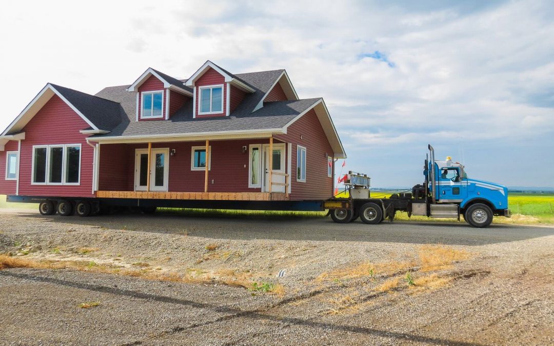 A large truck transporting a red house.