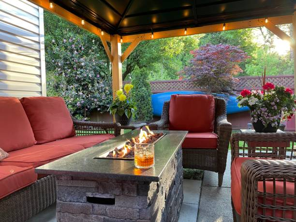 A patio with furniture and a fire pit featured in 10 Ways to Make Your Outdoor Patio More Comfortable.