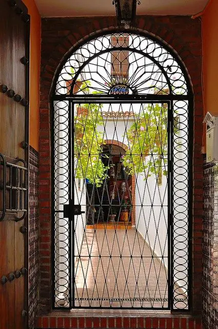 A house entrance with a Spanish-style iron gate.