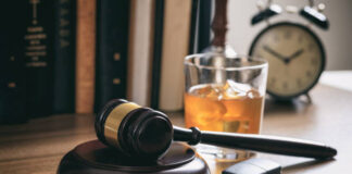 DUI concept. Law gavel, alcohol and car keys on a wooden desk.