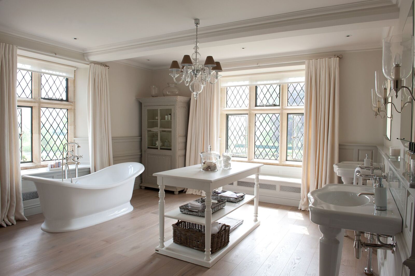 A white bathroom with a bathtub and sink showcasing elegant Bathroom design.