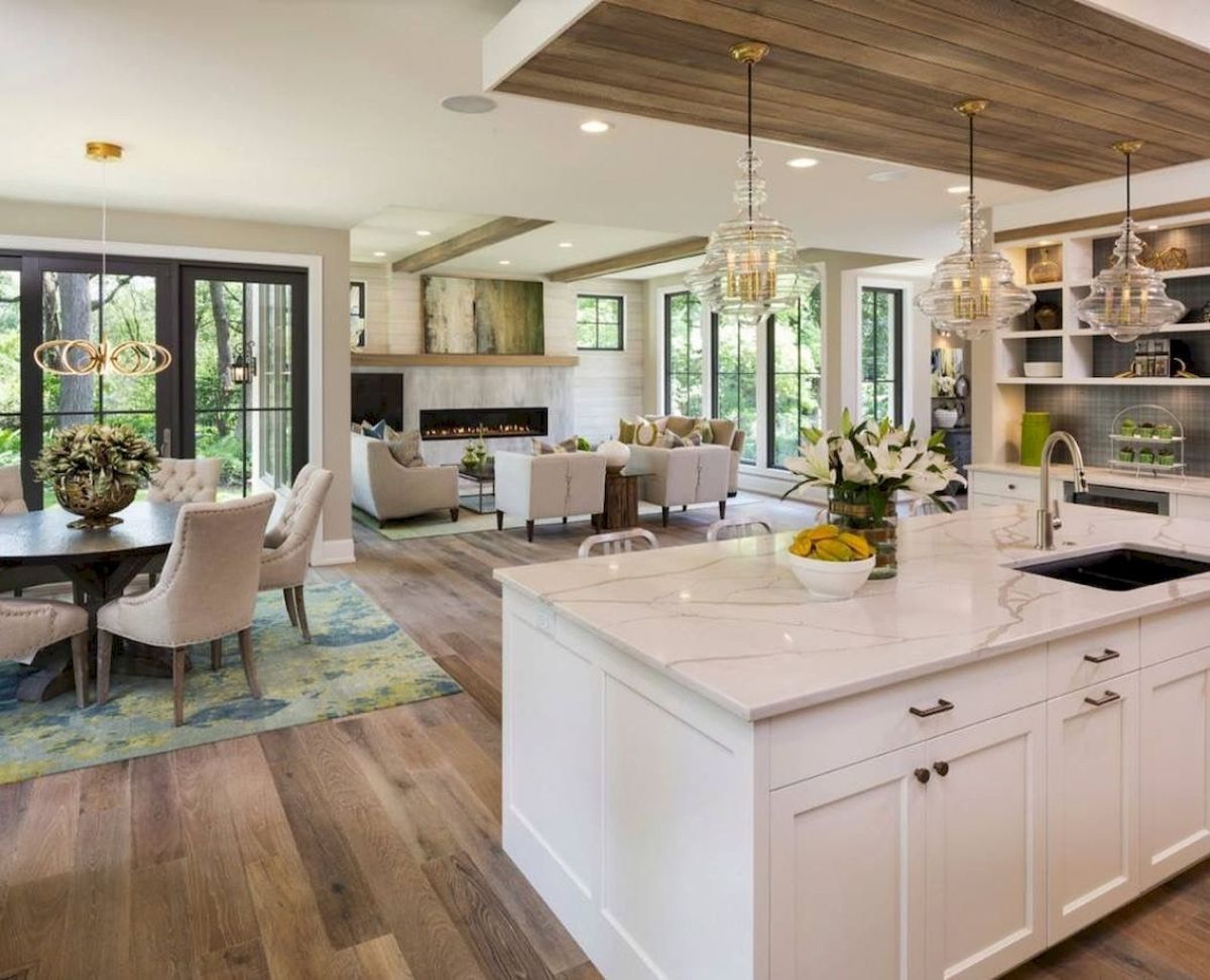 An open kitchen style featuring a center island and dining room.