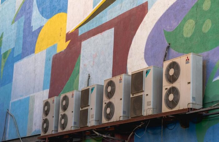A group of air conditioning units on the side of a building.