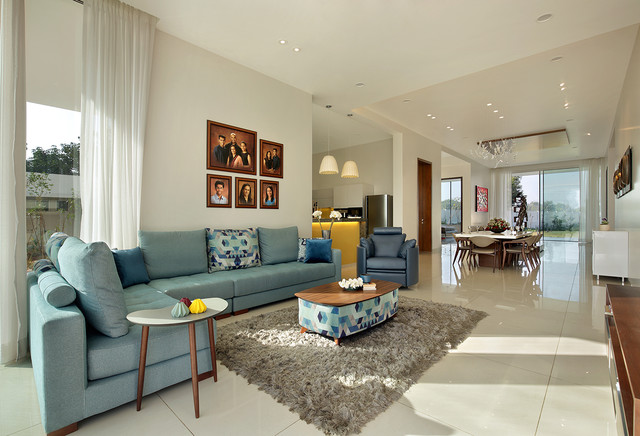 A contemporary living room with blue couches and a coffee table.