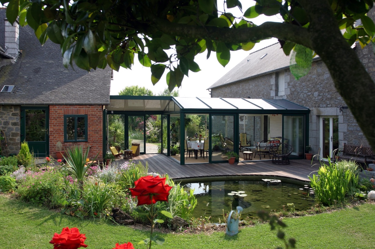 A house with a garden and pond, connecting indoor and outdoor spaces.