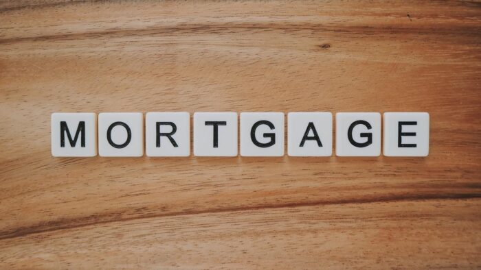 The word mortgage spelled out on a wooden table, representing Shared Ownership in the UK.