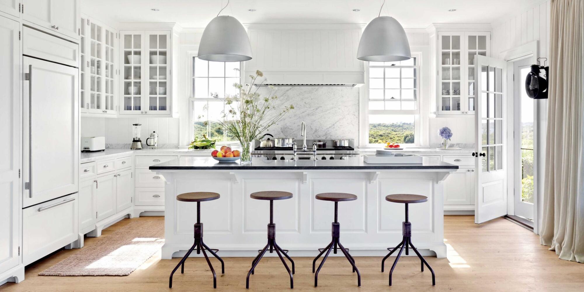A renovated kitchen with a central island and stools.