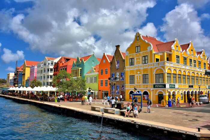 A vibrant row of buildings along the water, perfect for romantic getaways.