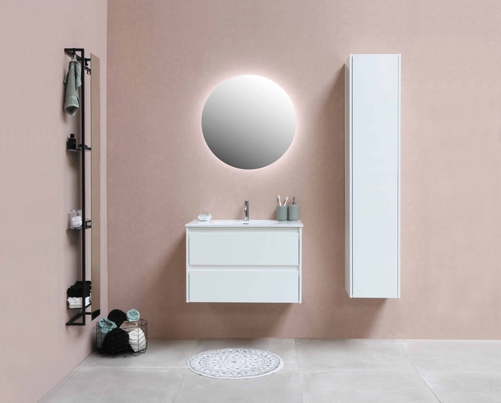 A colorful bathroom with a round mirror.