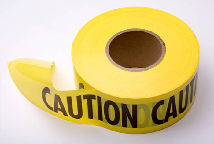 Industrial caution tape on a white background.
