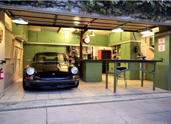 A green garage featuring a black car, perfect for DIY projects.