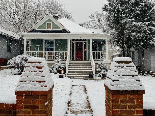 A snow-covered house with bricks, providing an eco-friendly and cozy atmosphere.