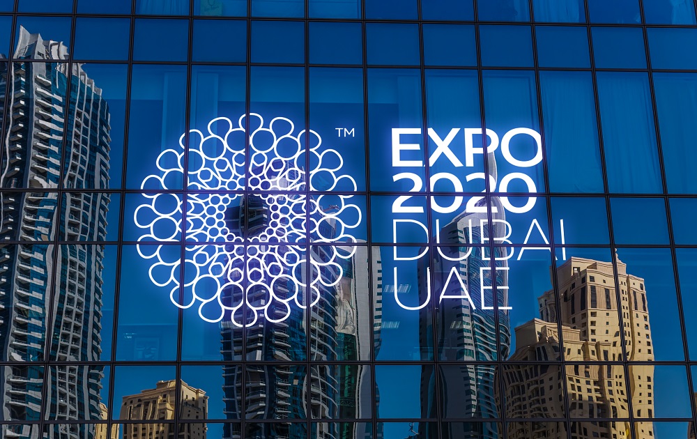 The logo for Expo 2010 is reflected in the glass of a building at Expo 2020 Dubai.