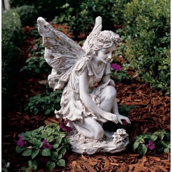A garden featuring a fairy statue that creates an atmosphere resembling art.