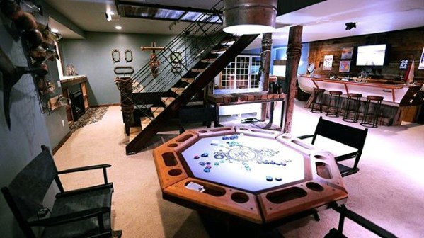 A man cave with a game room featuring a table and chairs.