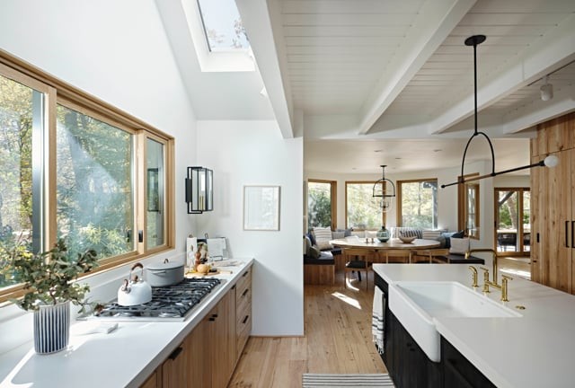 A kitchen with wood floors and ample natural light from a skylight.