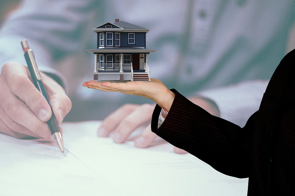 A person holding a model house - Divorce and House