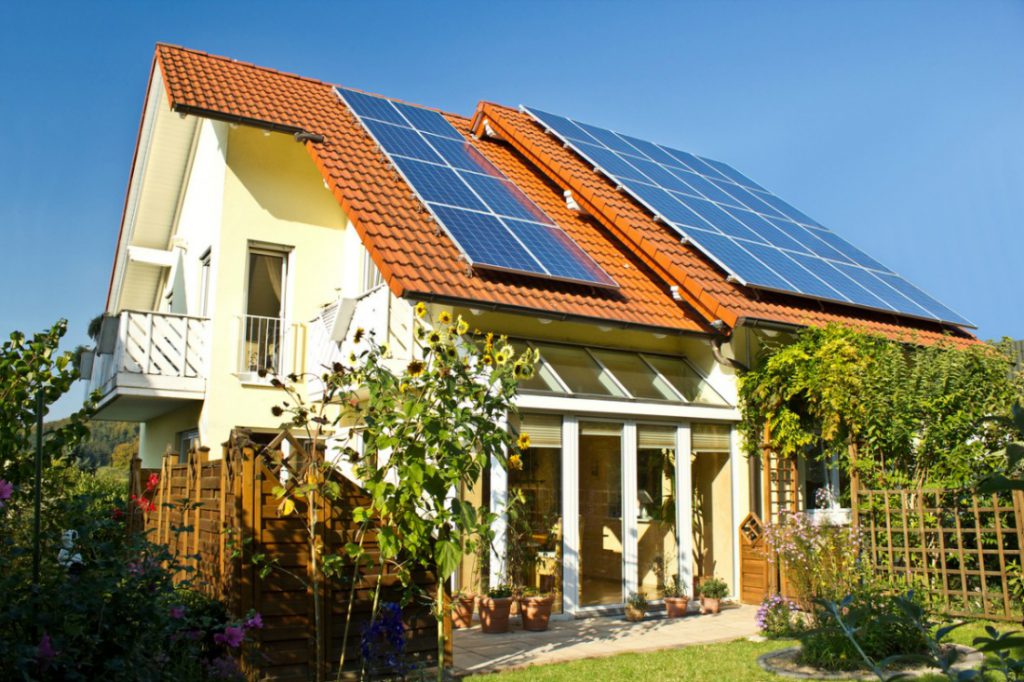 An eco-friendly home with solar panels on the roof.