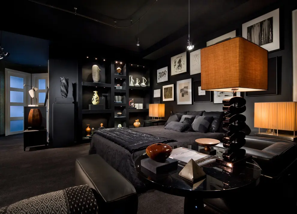 A bedroom with black walls and a bed.