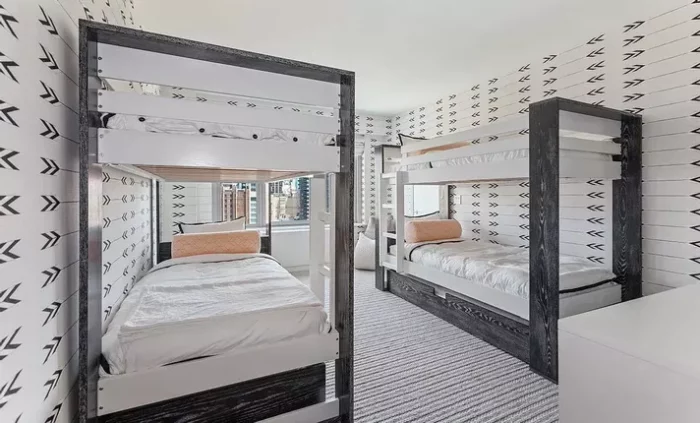 Two bunk beds in a fantasy kids' room with black and white arrows.