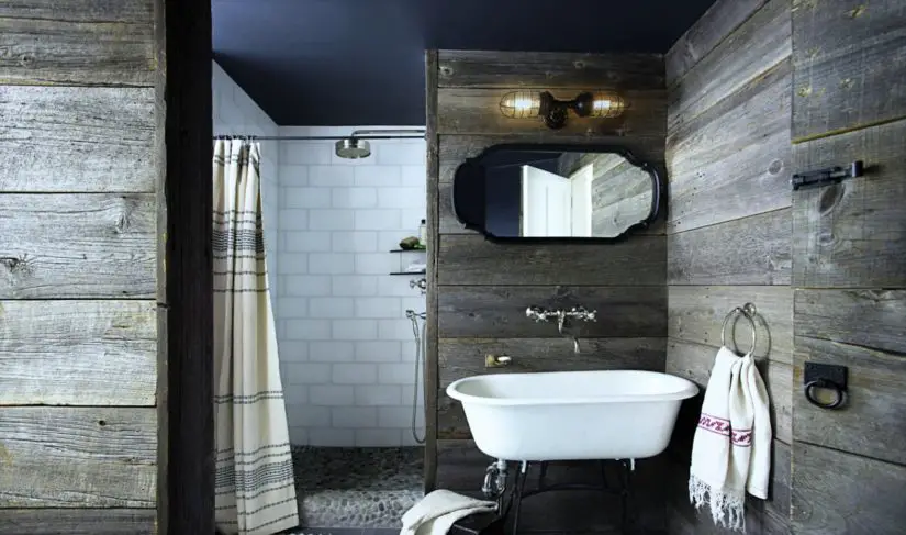 A bathroom with wooden walls and a white sink.