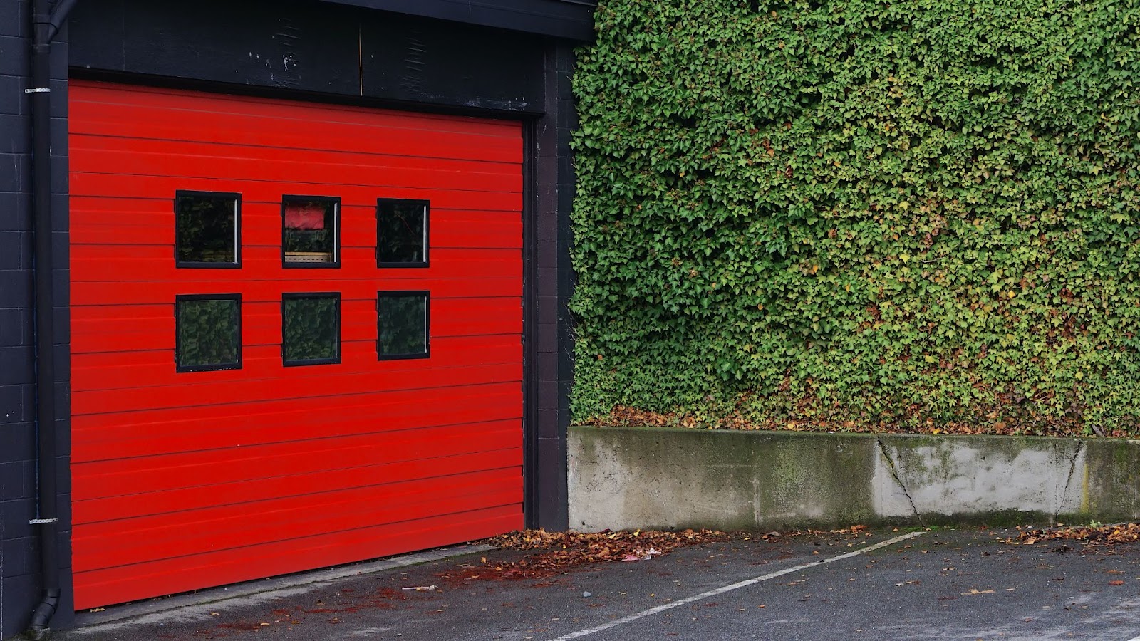 A red garage door sensor.