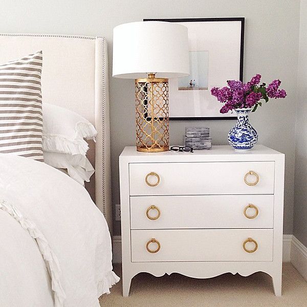 A bedroom with a white dresser.