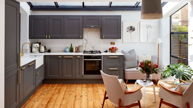 A renovated kitchen with grey cabinets and a skylight.